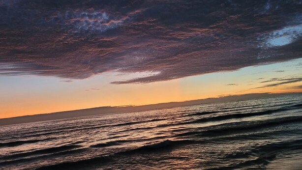 A beach scene with waves and a sunset. - Satellite Motel - Happy Daze 107 (Treasure Island)