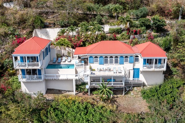 A large, multi-story house with a red roof, multiple balconies, and a swimming pool. - Awesome views, private pool, air conditioning, close to beaches, restaurants! (St John)