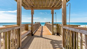 A wooden pier leading to a beach with a wooden pergola overhead. - Palacio 3/2 on 17th Floor with a Million Dollar View (Pensacola)