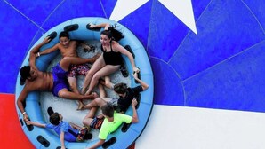 A group of people on a blue inflatable raft on a blue and white floor. - WaterFront View 2 BDR 1.5 BA Home (Katy)