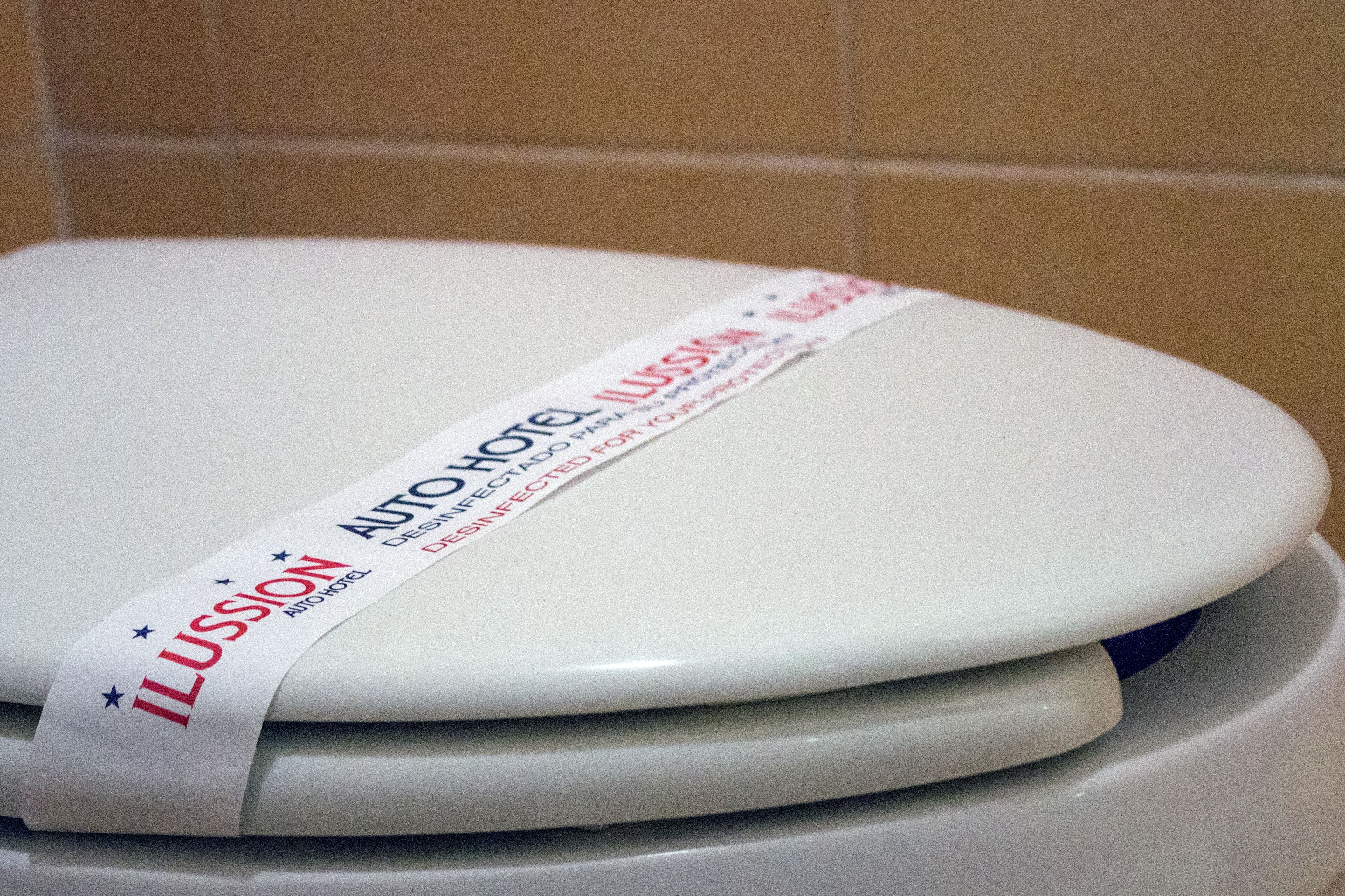 A white toilet with a label that reads "AUTO KOTEL" and "ILUSION".