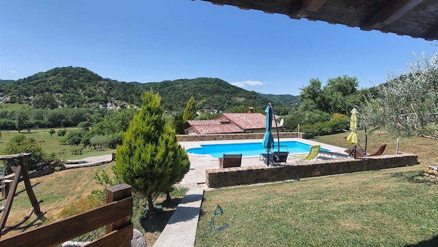 A pool area with a view of a mountainous landscape.