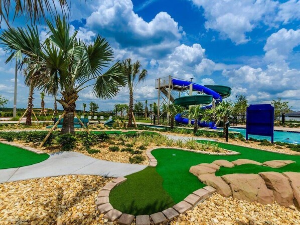 A water park with multiple slides and a pool.