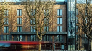 A modern building with a brick facade, multiple windows, and a sign reading "Dublin One". - Dublin One Hotel (Dublin)