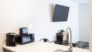 A modern kitchen with a built-in microwave, coffee maker, and sink. - New Modern Apartment Near Ft. Huachuca (225) (Sierra Vista)
