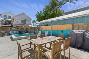 A backyard with a pool, outdoor furniture, and a barbecue grill. - One Lot off the Beach, a Sophisticated Chic East Beach Retreat w Heated Pool (Saint Simons Island)