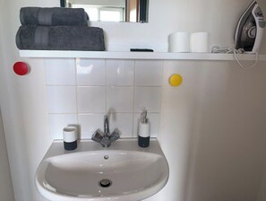 Shower, hair dryer, towels, toilet paper