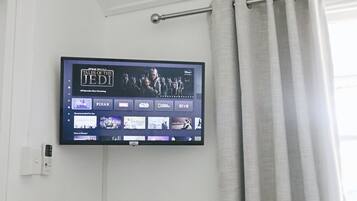 A flat-screen TV mounted on a wall displaying the Star Wars Tales of the Jedi series.