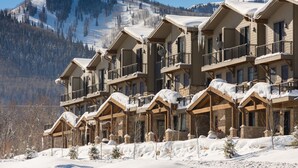 A multi-story lodge with balconies and a snowy mountain backdrop. - Central Location, Hot Tub, Chef (Park City)