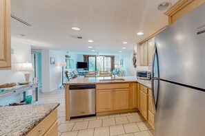 Enjoy cooking in this well-lit kitchen with a central island, dishwasher, refrigerator, and oven.