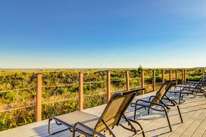 Relax on the deck surrounded by lush greenery.