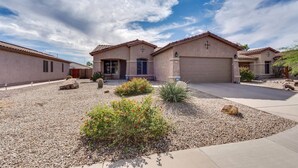 A residential area with two houses featuring stucco exteriors and tiled roofs. - Dive Into Spring in Mesa | Community Pool, Hot Tub, Tennis & Hoops (Mesa)