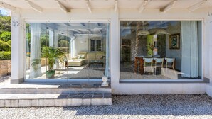 Een huis met een patio, een eettafel en stoelen.