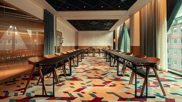 A conference room with a geometric patterned carpet, long tables, and chairs.