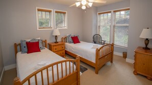 A bedroom with two single beds, a ceiling fan, and two windows with blinds. - Peaceful Blue Ridge Getaway at Echota (Boone)