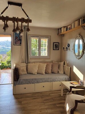 Relax in a cozy seating area with a bench and storage drawers, offering a view of the outdoors.