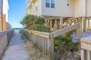 A wooden boardwalk leading to beach houses with a view of the ocean. - Over The Moon - 4 BR home, Oceanfront B-Lot with Amazing Views! Dog Friendly! (Surf City)