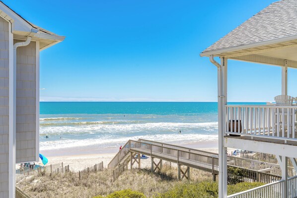A beach view with a wooden structure and a clear sky. - Over The Moon - 4 BR home, Oceanfront B-Lot with Amazing Views! Dog Friendly! (Surf City)