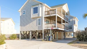 A two-story building with a balcony on the second floor.