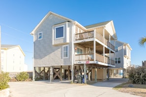 A two-story building with a balcony on the second floor.