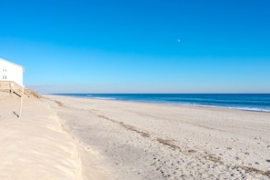 A beach with a white building, sandy shore, and ocean. - Over The Moon - 4 BR home, Oceanfront B-Lot with Amazing Views! Dog Friendly! (Surf City)