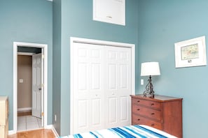 A bedroom with a bed, a wardrobe, a dresser, and a door leading to another room. - Over The Moon - 4 BR home, Oceanfront B-Lot with Amazing Views! Dog Friendly! (Surf City)