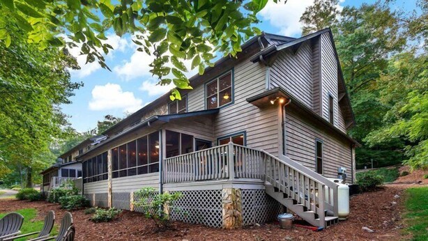 A two-story house with a covered porch, a staircase, and a deck. - Blue Ridge View | Pet Friendly, Deck, Grill + EV Charger (Marion)