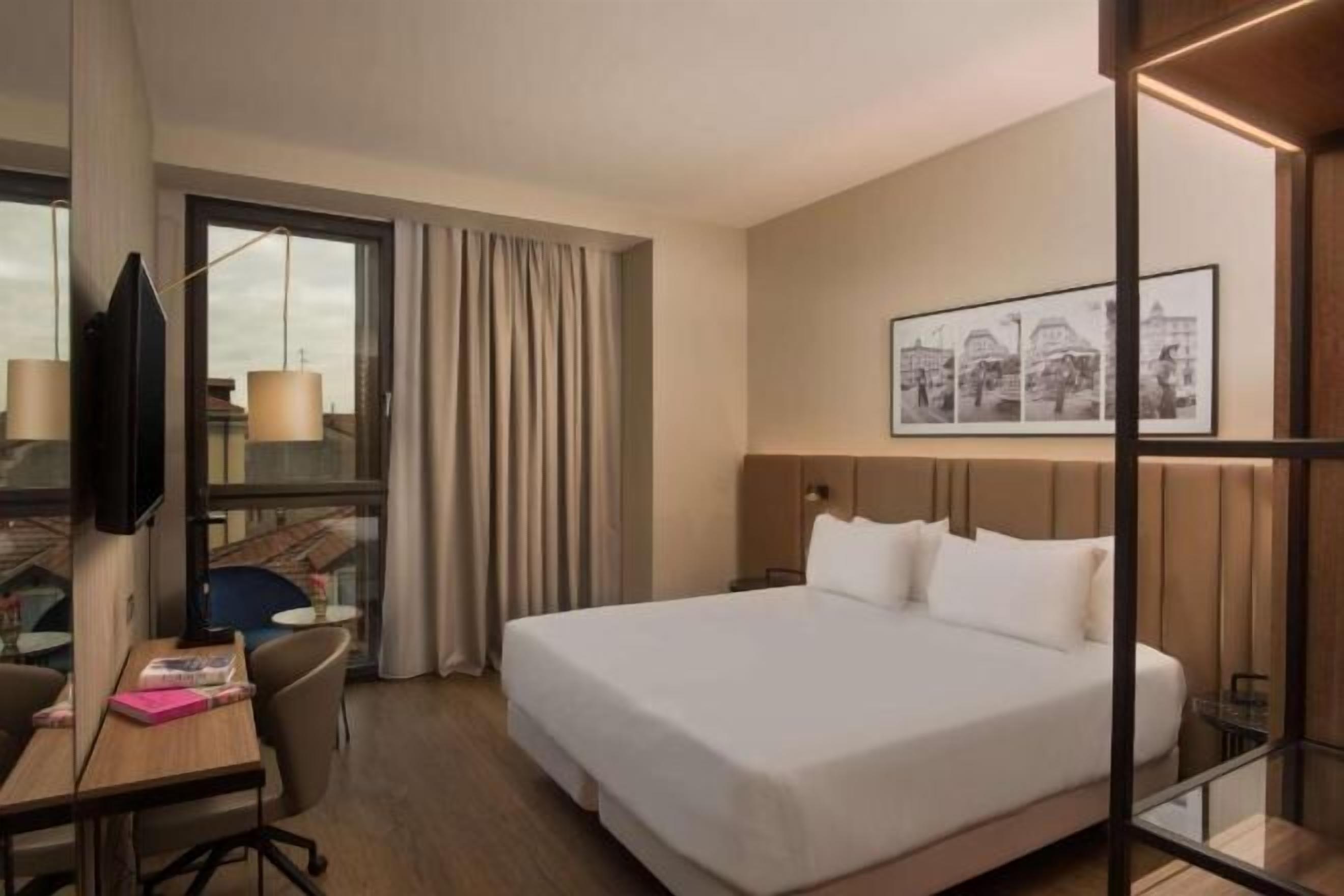 Minibar, desk, laptop workspace, bed sheets