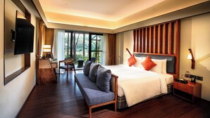 A modern hotel room with a large bed, a bench, a desk, and a TV. - Rosetta-Sakleshpur (Alur)