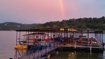 Guests can enjoy waterfront dining and relaxation at this scenic dock area with seating and tables.
