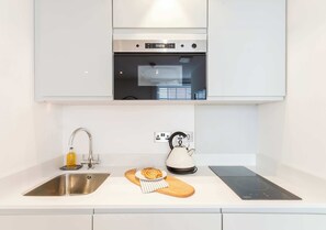 Fridge, microwave, stovetop, cookware/dishes/utensils