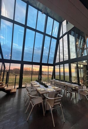 A spacious dining area with large windows offering a view of the outdoors.