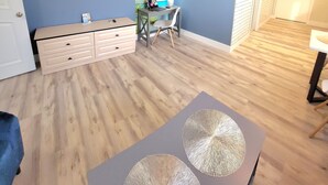 Une chambre moderne équipée d’une télévision, d’un bureau, d’une chaise et d’un grand tableau accroché au mur.