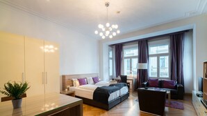 A modern hotel room with a large bed, a desk, a sofa, and a TV. - Vienna Residence, City Hall - Parliament #6411 (Vienna)