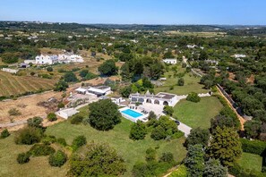 An aerial view of a large estate with multiple buildings, a swimming pool, and surrounding greenery. - Villa Azzurrato by Villa Plus (Ceglie Messapica)