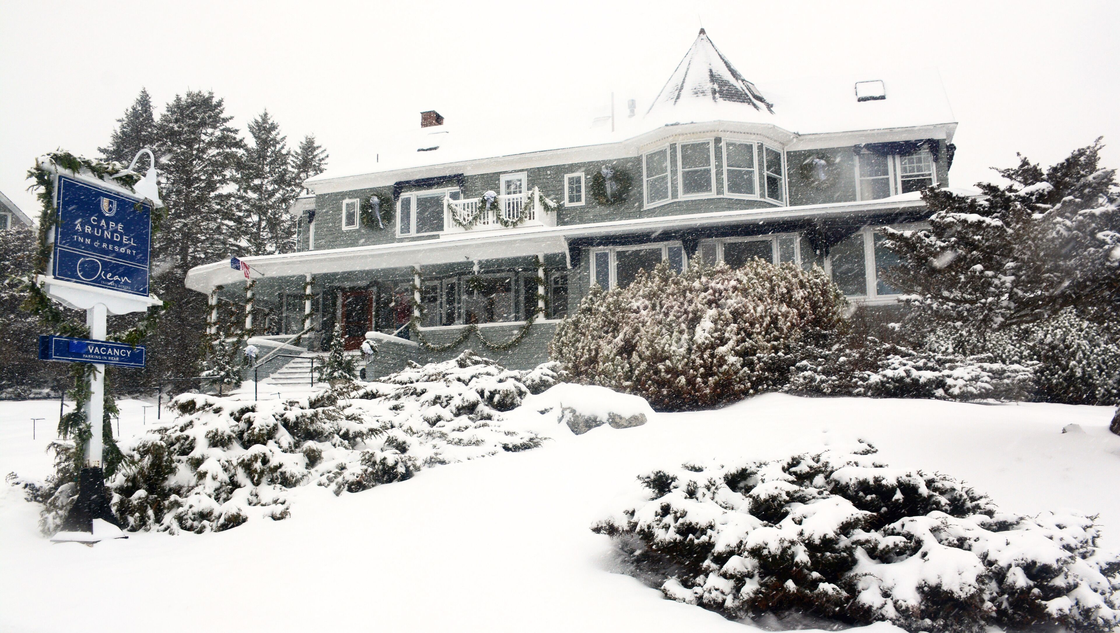 A large, two-story building with a prominent entrance and a covered porch.