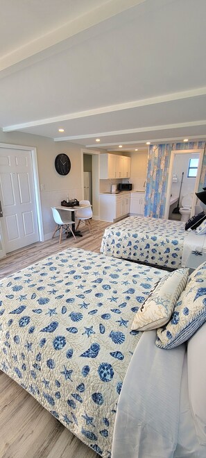 Cozy retreat with a large bed, sofa, kitchenette, and dining area.