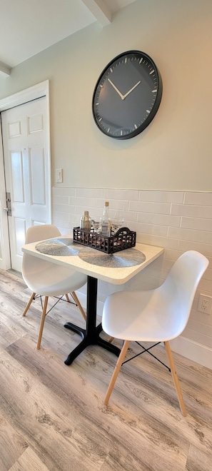 Enjoy meals at the round dining table with two chairs.