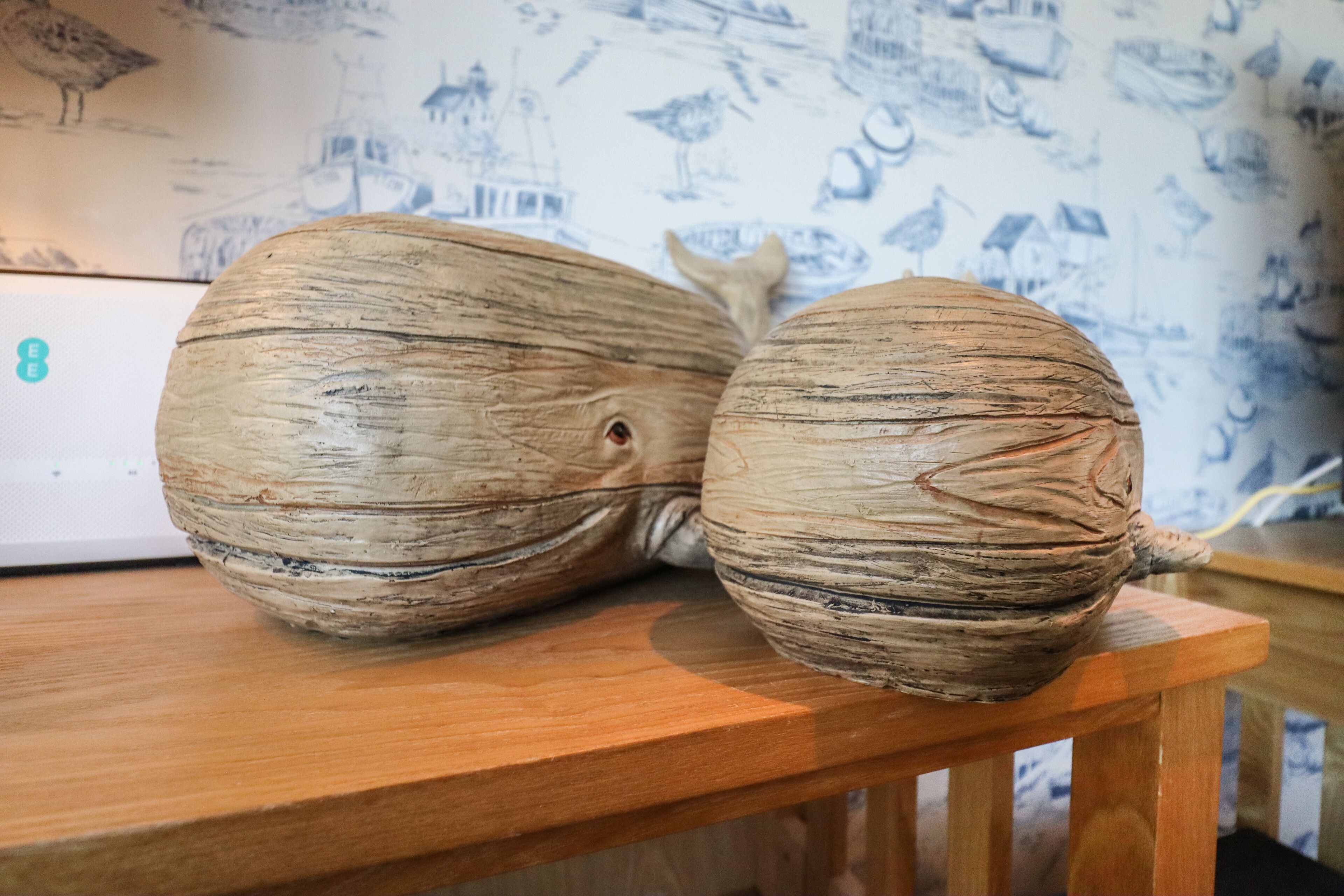Two large, textured ceramic objects on a wooden table.