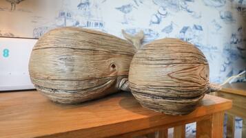 Two large, textured ceramic objects on a wooden table.