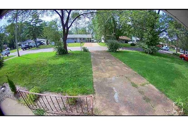 driveway leads to a charming suburban home.
