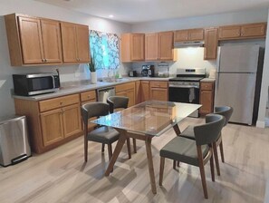 Enjoy cooking in this well-equipped kitchen with an oven, microwave, and stainless steel appliances.