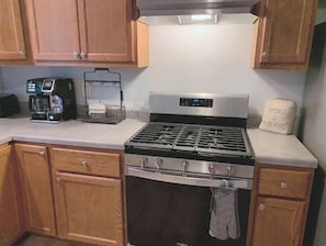 Enjoy cooking in this well-equipped kitchen with a gas range, oven, and coffee maker.