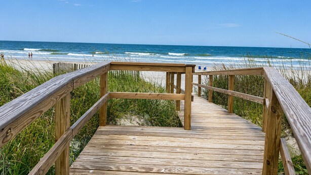 A wooden boardwalk leading to a beach with ocean views. - Beach Breezes - Oceanside, 4 bedrooms (Pawleys Island)