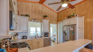 A spacious kitchen with wooden cabinets, a large island, stainless steel appliances, and a ceiling fan. - Ocean Breeze - Near Ocean, 5 Bedrooms, Litchfield (Litchfield)
