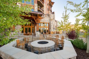 A stone building with a fire pit and outdoor seating area.