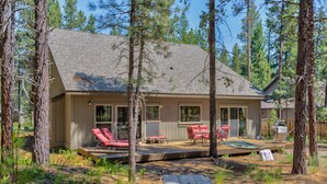 A cabin with a deck, outdoor seating, and a picnic table. - Jacinto Road 16831 (Bend)