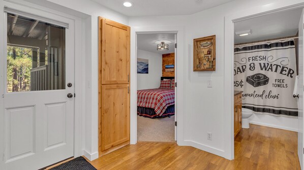 Experience a cozy sleeping area with a neatly made bed, shower, and thoughtful touches.