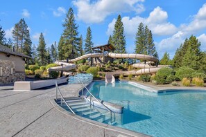 Relax by the pool surrounded by lush greenery and enjoy a thrilling water slide experience.