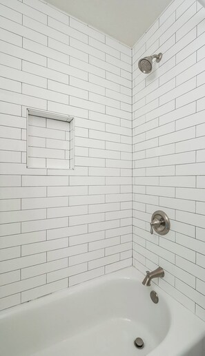 Bathtub, hair dryer, towels, soap